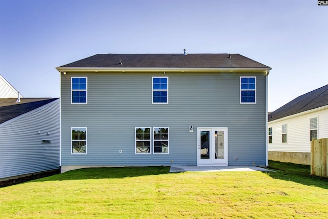 rear view of property with a patio, a lawn, and fence