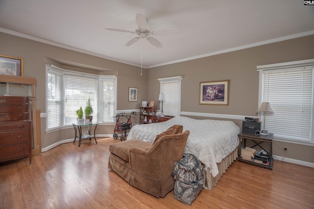 bedroom with ornamental molding, a ceiling fan, baseboards, and wood finished floors