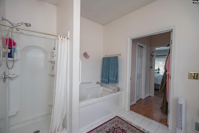 full bathroom with tile patterned flooring, a shower stall, a bath, and connected bathroom