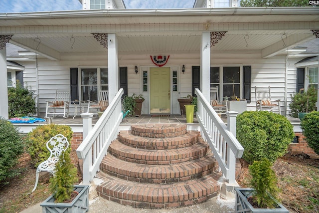 view of exterior entry with a porch