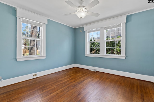 unfurnished room featuring visible vents, plenty of natural light, baseboards, and hardwood / wood-style flooring