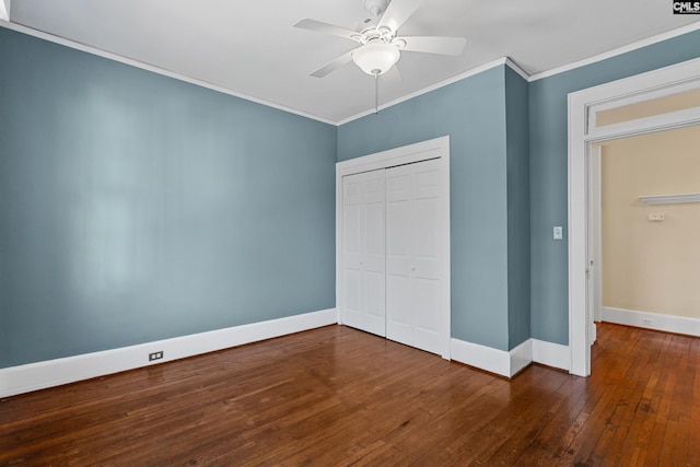 unfurnished bedroom featuring hardwood / wood-style flooring, baseboards, and crown molding