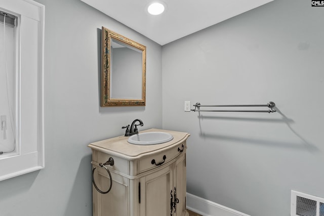 bathroom featuring baseboards, visible vents, and vanity