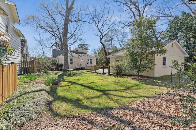 view of yard with an outbuilding and fence