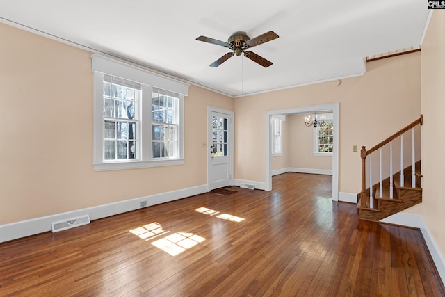 foyer entrance with baseboards, visible vents, stairway, ornamental molding, and hardwood / wood-style floors