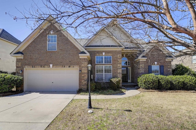 traditional-style house with a garage, brick siding, driveway, and a front lawn