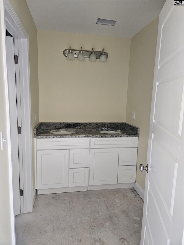 bathroom with concrete floors and double vanity