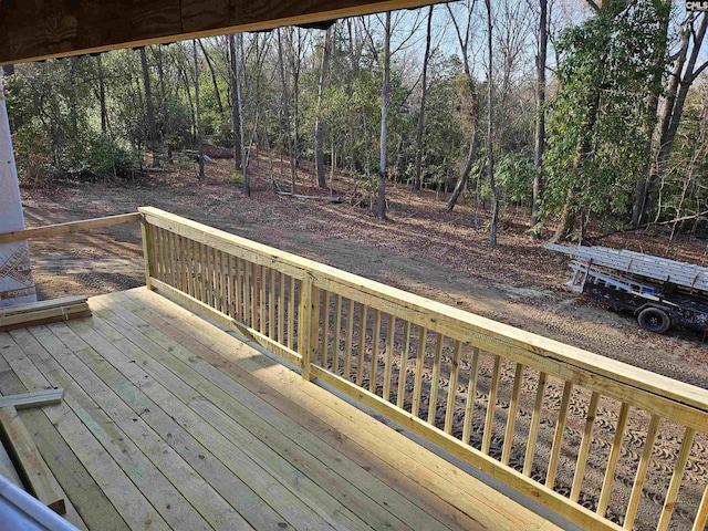 wooden terrace with a view of trees