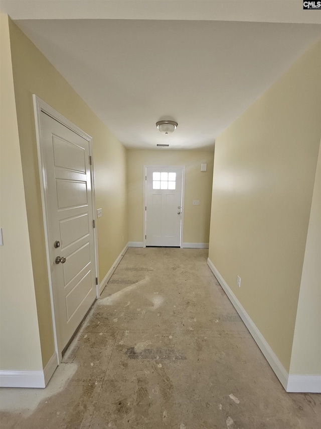 doorway featuring baseboards