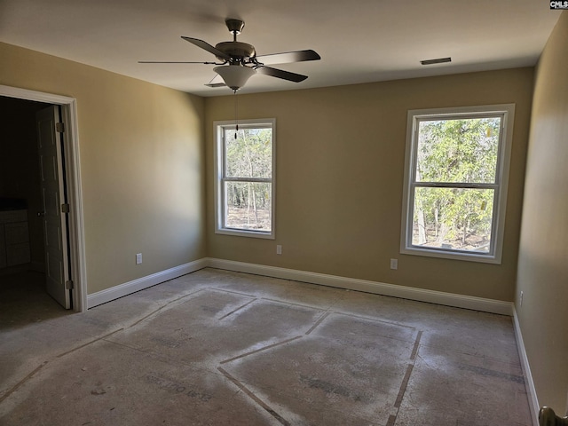 spare room featuring visible vents, baseboards, and a ceiling fan