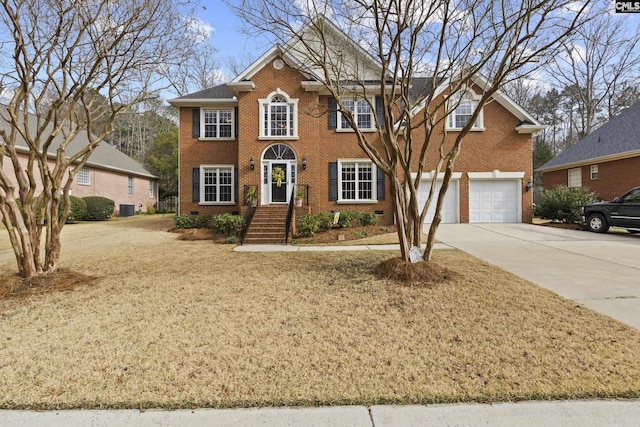 colonial inspired home with driveway, crawl space, an attached garage, central AC, and brick siding