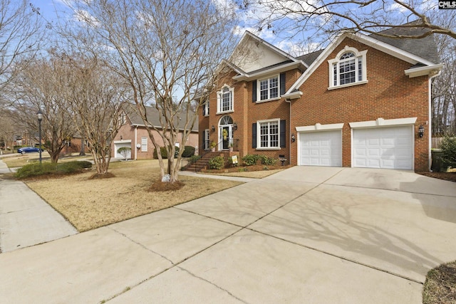 view of front of home with a garage, brick siding, and driveway