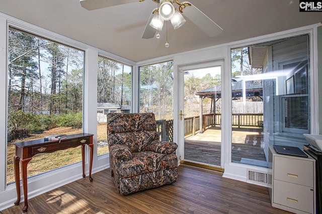 sunroom / solarium with ceiling fan and visible vents