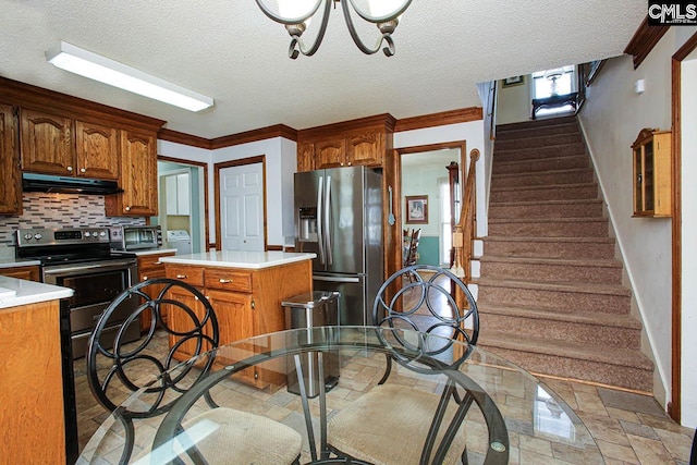 kitchen with tasteful backsplash, a kitchen island, appliances with stainless steel finishes, light countertops, and ventilation hood