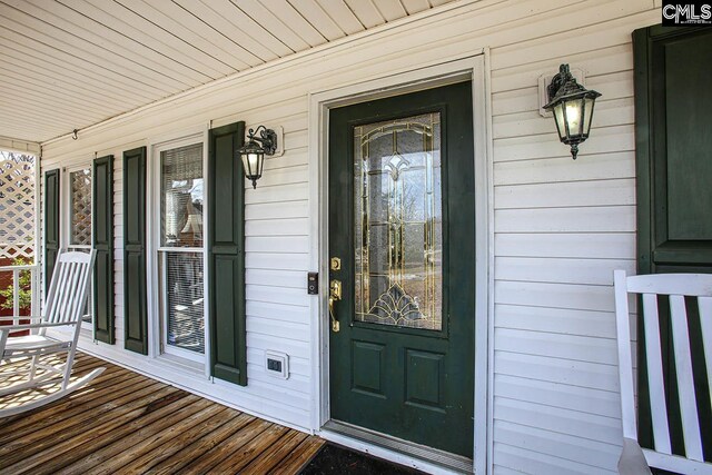 doorway to property featuring covered porch