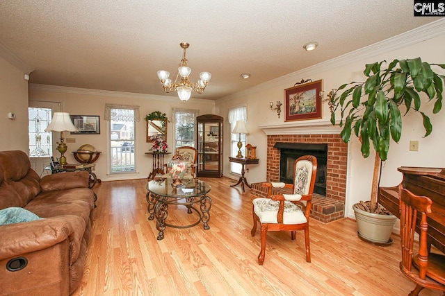 living room with a brick fireplace, crown molding, a textured ceiling, and wood finished floors