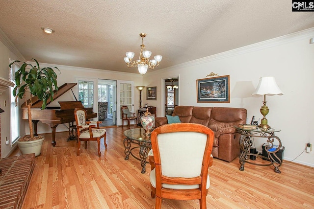 interior space with light wood-style floors, a chandelier, and ornamental molding