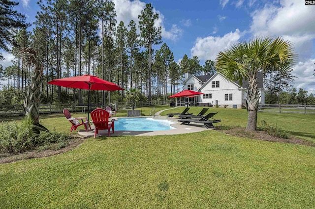 view of swimming pool featuring a water slide, a lawn, a patio area, and fence