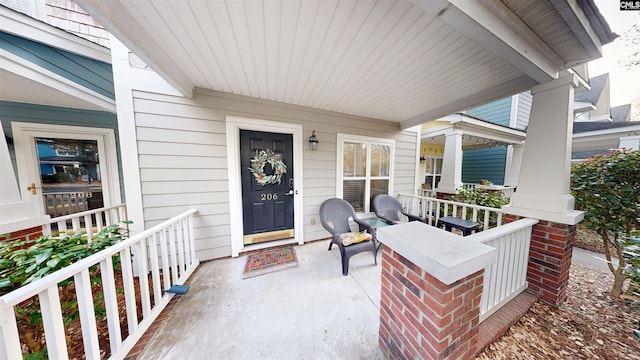 view of exterior entry with a porch