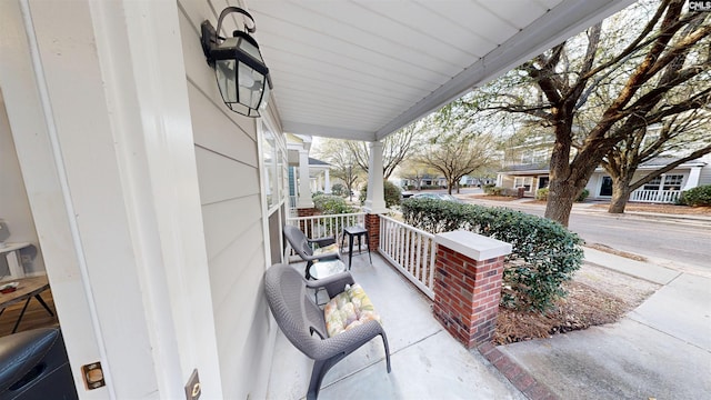 view of patio / terrace with a porch and a residential view