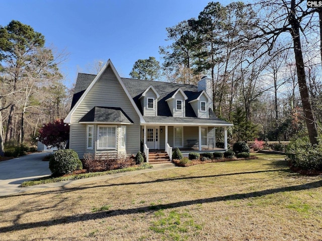 cape cod-style house featuring covered porch, a chimney, and a front yard