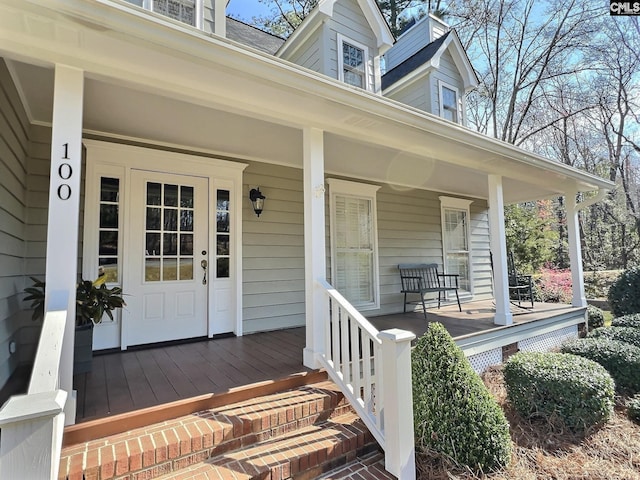 view of exterior entry featuring a porch