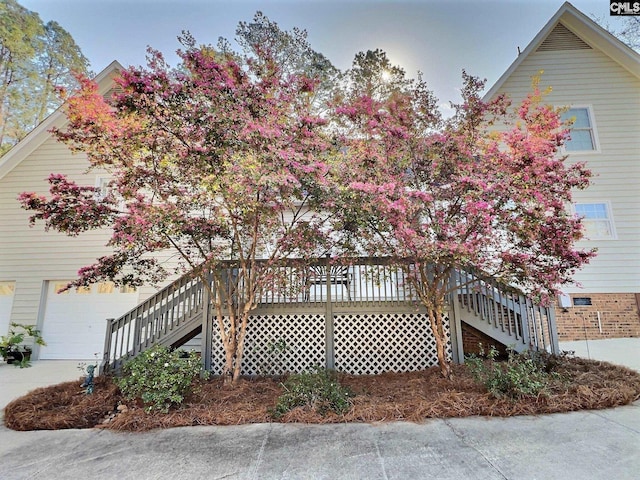 view of property exterior with stairs and a garage