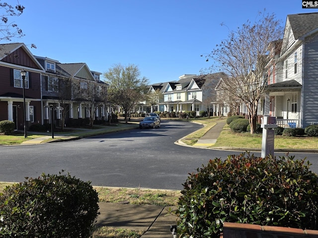 view of street with a residential view, curbs, and sidewalks