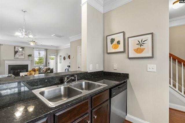 kitchen with a sink, a glass covered fireplace, dark brown cabinetry, crown molding, and dishwasher