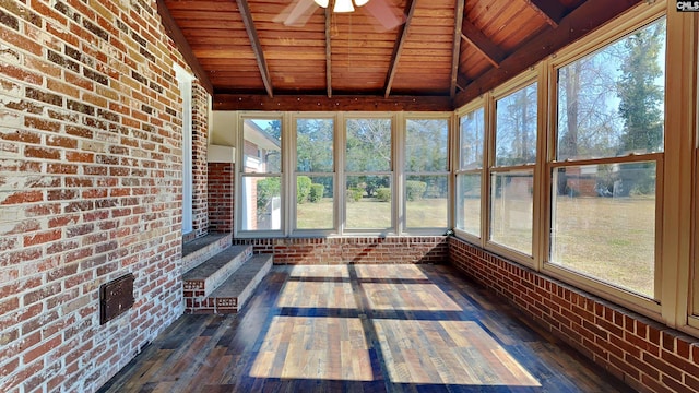 unfurnished sunroom featuring wood ceiling, ceiling fan, and lofted ceiling with beams