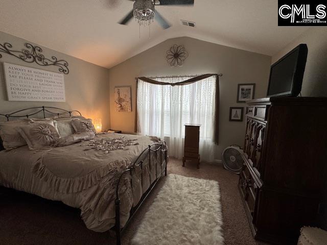 carpeted bedroom with ceiling fan, visible vents, and vaulted ceiling