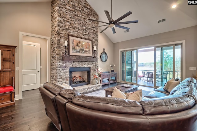 living room with a fireplace, visible vents, wood finished floors, high vaulted ceiling, and baseboards