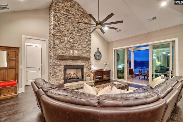 living room with a fireplace, visible vents, and wood finished floors