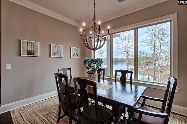 dining room featuring plenty of natural light, a water view, crown molding, and baseboards