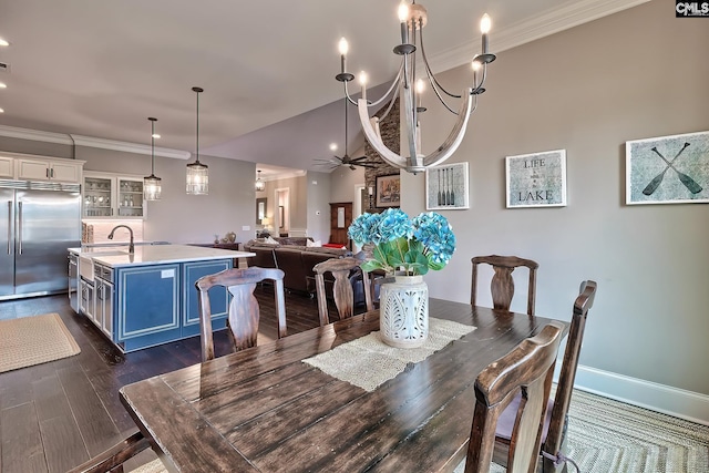 dining room with dark wood-style floors, ornamental molding, a ceiling fan, and baseboards