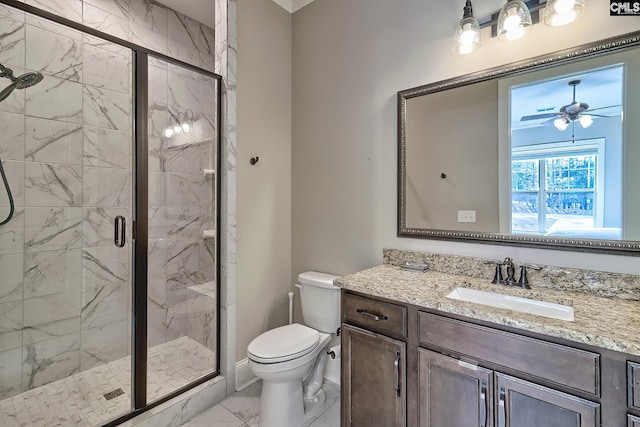 bathroom with marble finish floor, toilet, a ceiling fan, a stall shower, and vanity