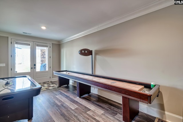 game room featuring wood finished floors, visible vents, baseboards, french doors, and crown molding