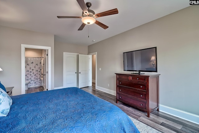 bedroom with ceiling fan, connected bathroom, baseboards, and wood finished floors