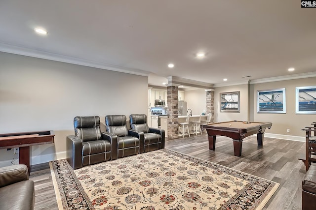 recreation room with baseboards, dark wood-style flooring, decorative columns, and crown molding