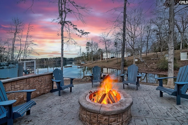 view of patio / terrace featuring a fire pit and a water view