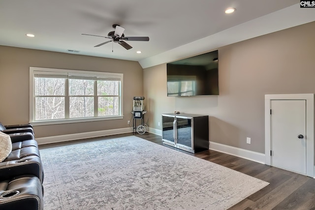 living room with baseboards, visible vents, a ceiling fan, dark wood-style flooring, and recessed lighting