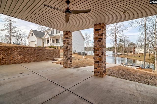 view of patio / terrace with a ceiling fan and a water view