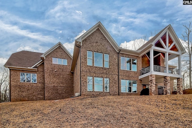 back of property featuring brick siding