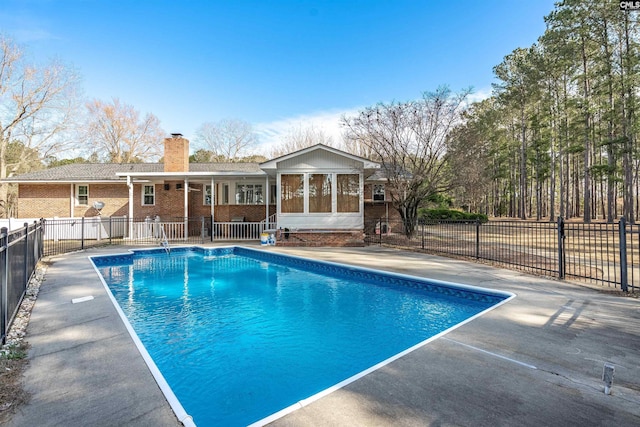 view of swimming pool featuring fence, a fenced in pool, and a patio