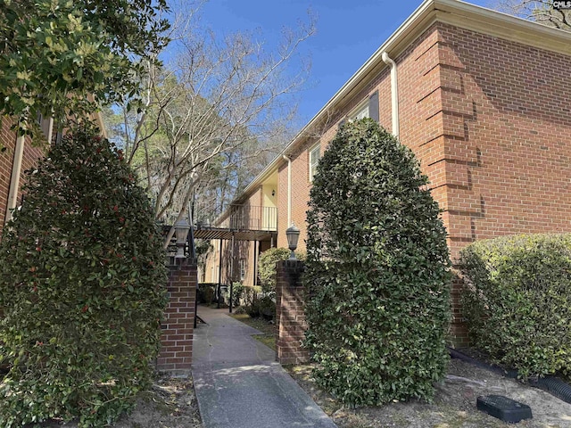 view of property exterior featuring brick siding