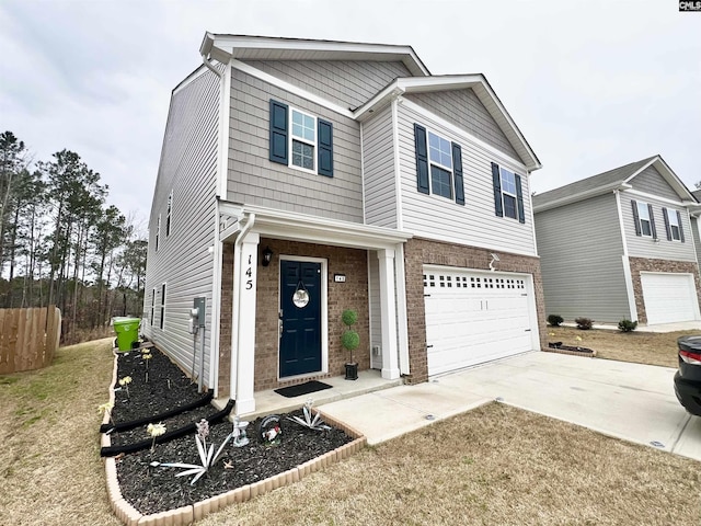 view of front of property with an attached garage, fence, concrete driveway, and brick siding