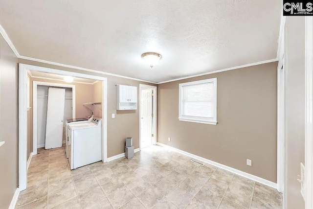 laundry area with laundry area, crown molding, washer and clothes dryer, and baseboards