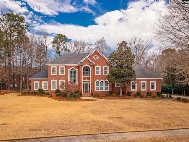 georgian-style home featuring brick siding