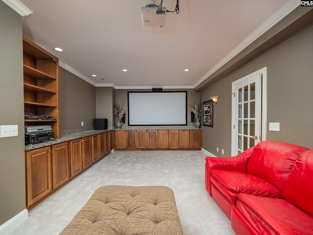 home theater room featuring crown molding, recessed lighting, baseboards, and light colored carpet