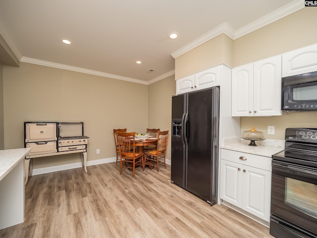 kitchen with light stone counters, light wood-style floors, white cabinets, black appliances, and crown molding